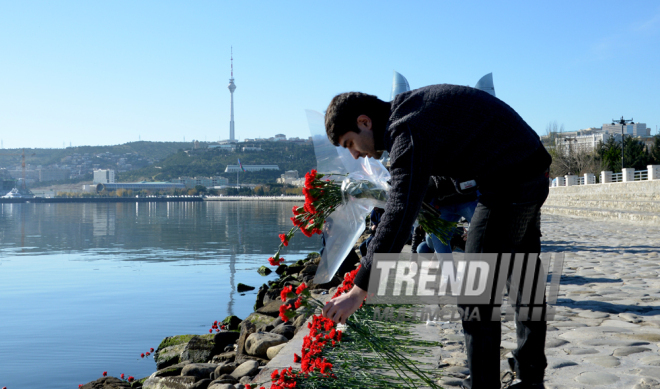 Baku residents bringing flowers to Seaside Boulevard to honor missing oil workers.  Azerbaijan, Dec.07, 2015